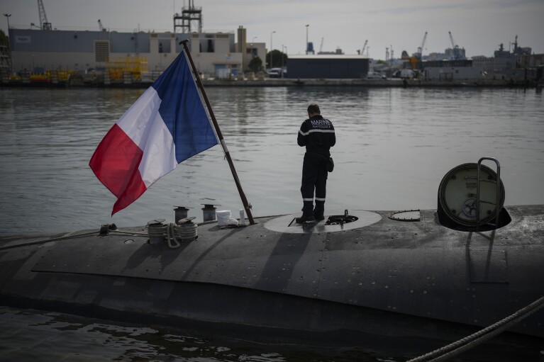 A sailor prepares a French Rubis-class submarine at the Toulon naval base in southern France, April 15, 2024. (AP Photo/Daniel Cole)