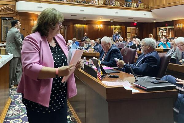 Indiana Republican Rep. Karen Engleman, center, yields to Democratic Rep. Ryan Hatfield, left, during a house session, Thursday, Aug. 4, 2022, in Indianapolis, when lawmakers failed to strip exceptions for rape and incest in a Senate-approved abortion ban being considered by the Indiana House. (AP Photo/Arleigh Rodgers)