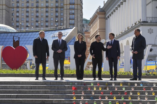 From left, Polish Prime Minister Donald Tusk, U.K. Prime Minister Keir Starmer, Ukraine's First Lady Olena Zelenska Olena Zelenska,Ukrainian President Volodymyr Zelenskyy, French President Emmanuel Macron and German Chancellor Friedrich Merz stand at the memorial of fallen Ukrainian soldiers at independence square in Kyiv, Ukraine, on Saturday, May 10, 2025. (AP Photo/Evgeniy Maloletka)