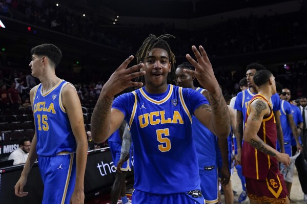 UCLA guard Brandon Williams, center, reacts after the team's win against Southern California during an NCAA college basketball game, Saturday, Jan. 27, 2024, in Los Angeles. (AP Photo/Ryan Sun)