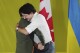 Prime Minister Justin Trudeau, right, embraces Ukrainian President Volodymyr Zelenskyy as he is introduced during a rally at the Fort York Armoury in Toronto on Friday, Sept. 22, 2023. (Chris Young/The Canadian Press via AP)
