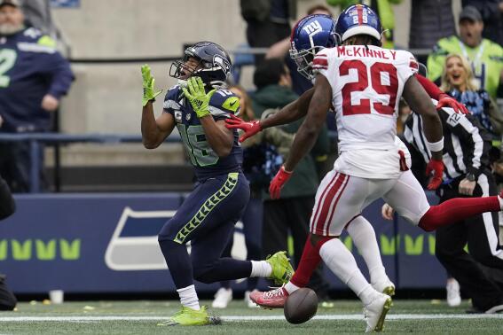 Seattle Seahawks wide receiver Tyler Lockett (16) reacts after an incomplete pass against New York Giants safety Xavier McKinney (29) and cornerback Adoree' Jackson during the second half of an NFL football game in Seattle, Sunday, Oct. 30, 2022. (AP Photo/Marcio Jose Sanchez)