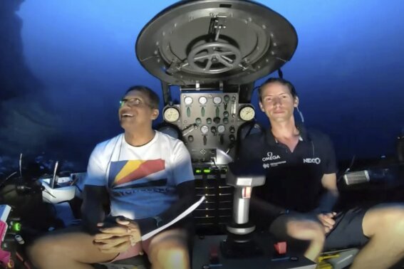 
              An image taken from video issued by Nekton shows Seychelles President Danny Faure, left, smiling after speaking from inside a submersible from the vessel Ocean Zephyr, under the water off the coast of Desroches, in the outer islands of Seychelles Sunday April 14, 2019. Faure toured the vessel and was presented with some of the findings and observations made by a British-led science expedition documenting changes taking place beneath the waves that could affect billions of people in the surrounding region over the coming decades (Nekton via AP)
            