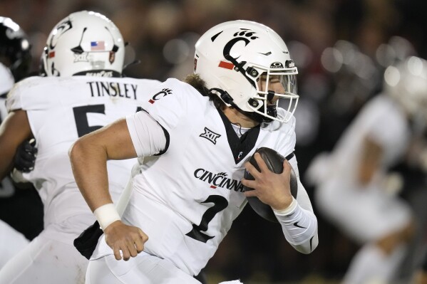 Cincinnati quarterback Brendan Sorsby (2) carries the ball up field during the first half of an NCAA college football game against Iowa State, Saturday, Nov. 16, 2024, in Ames, Iowa. (AP Photo/Charlie Neibergall)