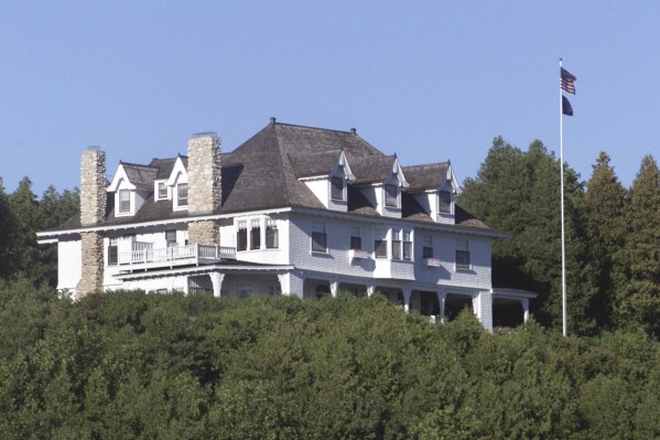 FILE - The Michigan governor's summer residence on Mackinac Island, Mich., is shown on Sept. 18, 1999. A man dressed in black who works for a research group specializing in opposition research about Democrats was stopped while climbing a bluff in August near Michigan Gov. Gretchen Whitmer's summer residence, according to a police report obtained by The Associated Press. (AP Photo/Carlos Osorio, File)