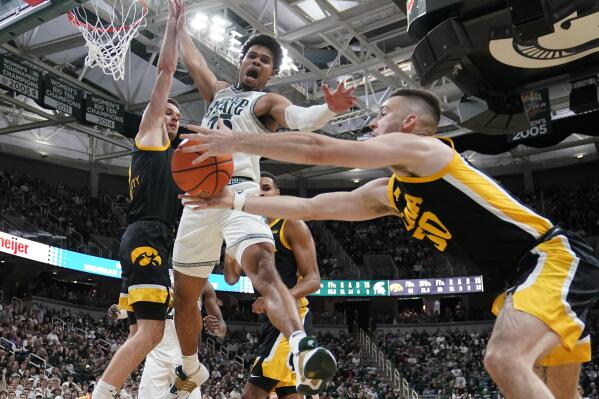 Iowa guard Connor McCaffery recovers the rebound next to Michigan State forward Malik Hall during the second half of an NCAA college basketball game, Thursday, Jan. 26, 2023, in East Lansing, Mich. (AP Photo/Carlos Osorio)