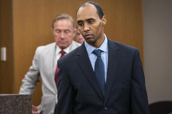 FILE - In this June 7, 2019 file photo, former Minneapolis police officer Mohamed Noor walks to the podium to be sentenced at Hennepin County District Court in Minneapolis. The Minnesota Supreme Court on Wednesday, Sept. 15, 2021, reversed the third-degree murder conviction of Noor who fatally shot an Australian woman in 2017, saying the charge doesn't fit the circumstances in this case. (Leila Navidi/Star Tribune via AP, Pool File)