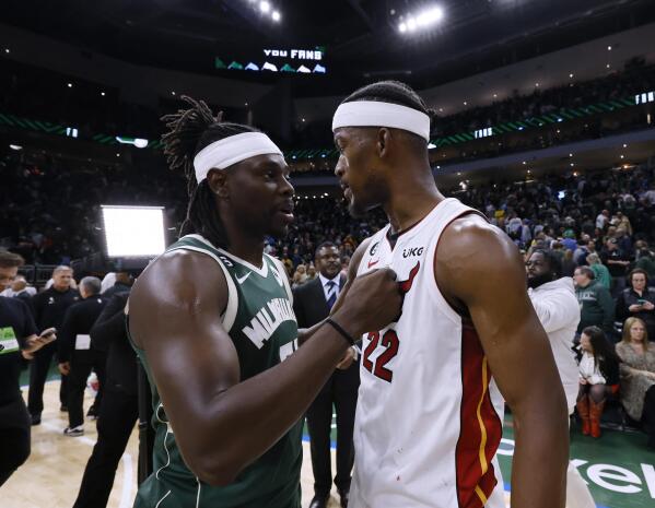 Milwaukee Bucks' Jrue Holiday, left, congratulates Miami Heat's Jimmy Butler after Game 5 in a first-round NBA basketball playoff series Wednesday, April 26, 2023, in Milwaukee. The Heat won 128-126 in overtime, eliminating the Bucks from the playoffs. (AP Photo/Jeffrey Phelps)
