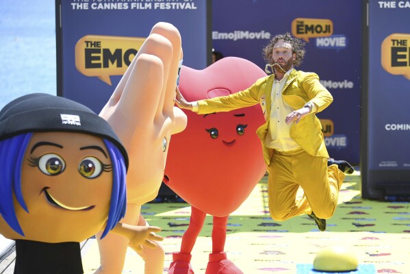 Actor T. J. Miller poses with characters during the photo call for the film The Emoji Movie, at the 70th international film festival, Cannes, southern France, Tuesday, May 16, 2017. (Photo by Arthur Mola/Invision/AP, File)
