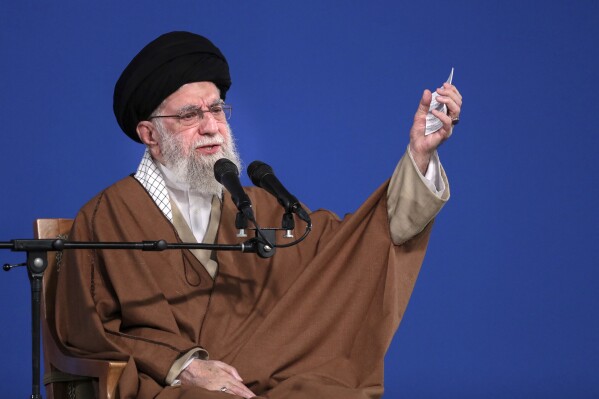 In this photo released by the official website of the office of the Iranian supreme leader, Supreme Leader Ayatollah Ali Khamenei speaks to a group of people and officials in Tehran, Iran, Friday, March 21, 2025. (Office of the Iranian Supreme Leader via AP)
