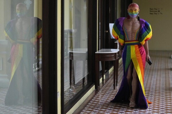 An LGBTQ participant leaves a news conference on the Bangkok Pride in Bangkok, Thailand , Monday, May 20, 2024. Thailand is kicking off its celebration for the LGBTQ+ community's Pride Month with a parade on Saturday, as the country is on the course to become the first nation in Southeast Asia to legalize marriage equality. (AP Photo/Sakchai Lalit)