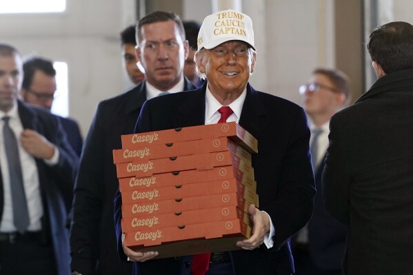 Republican presidential candidate former President Donald Trump arrives to deliver pizza to fire fighters at Waukee Fire Department in Waukee, Iowa on Sunday. (AP Photo/Andrew Harnik)