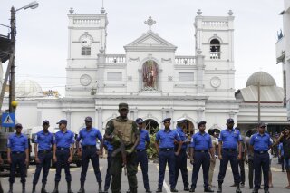 
              Sri Lankan Army soldiers secure the area around St. Anthony's Shrine after a blast in Colombo, Sri Lanka, Sunday, April 21, 2019. A Sri Lanka hospital spokesman says several blasts on Easter Sunday have killed dozens of people. (AP Photo/Eranga Jayawardena)
            