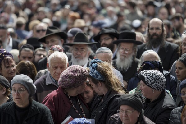 Family and friends of Yitzhak Zeiger mourn during his funeral at a cemetery in Jerusalem, Israel, Friday, March 1, 2024. Two Israelis, including Zeiger, were killed in a Palestinian shooting attack at a gas station near the Jewish settlement of Eli, in the occupied West Bank on Thursday, the Israeli military said. (AP Photo/Leo Correa)
