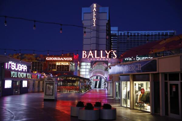 FILE - An empty outdoor mall at Bally's Las Vegas along the Las Vegas Strip during the coronavirus pandemic on April 14, 2020. Some shuffling among owners has some Las Vegas Strip properties destined in coming months for rebranding, demolition, reconstruction, and the addition of familiar names. Caesars Entertainment plans to rename Bally's Las Vegas as the Horseshoe Las Vegas, drawing on a name made famous at a downtown gambling hall that was the original home of the World Series of Poker. (AP Photo/John Locher, File)