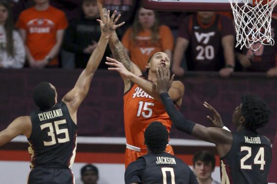 Virginia Tech's Lynn Kidd (15) scores past Florida State defenders Matthew Cleveland (35) Chandler Jackson (0) and Naheem McLeod (24) during the first half of an NCAA college basketball game, Saturday, March 4, 2023 in Blacksburg, Va. (Matt Gentry/The Roanoke Times via AP)