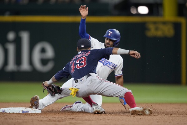 Boston Red Sox shortstop Ceddanne Rafaela (43) applies the tag on Texas Rangers' Marcus Semien at second to complete the double play in the second inning of a baseball game, Wednesday, Sept. 20, 2023, in Arlington, Texas. Corey Seager was out at first on the play. (AP Photo/Tony Gutierrez)