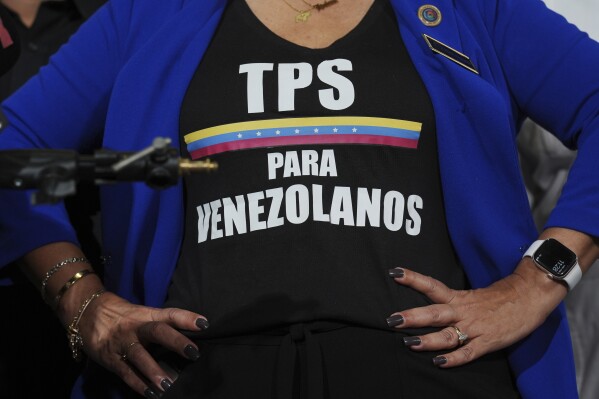 Activist Helene Villalonga wears a tee-shirt calling for Temporary Protected Status for Venezuelans during a press conference to denounce changes to the protections that shielded hundreds of thousands of Venezuelans from deportation, Feb. 3, 2025, in Doral, Fla. (AP Photo/Rebecca Blackwell, File)