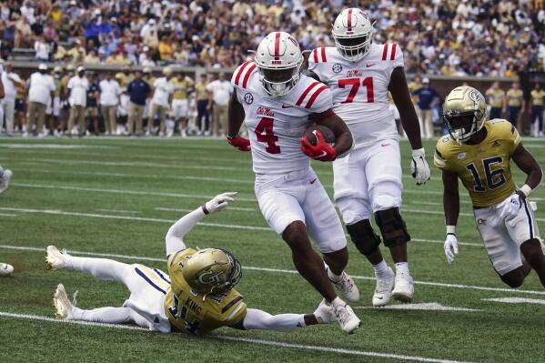 Mississippi running back Quinshon Judkins (4) gets past Georgia Tech defensive back Jaylon King (14) as he runs for a touchdown in the first half of an NCAA college football game, Saturday, Sept. 17, 2022, in Atlanta. (AP Photo/John Bazemore)