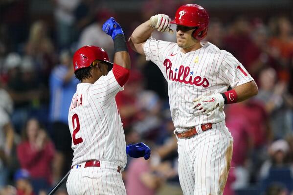 Philadelphia Phillies' J.T. Realmuto, right, and Jean Segura celebrate after Realmuto's home run against Washington Nationals pitcher Patrick Corbin during the sixth inning of a baseball game, Friday, Sept. 9, 2022, in Philadelphia. (AP Photo/Matt Slocum)
