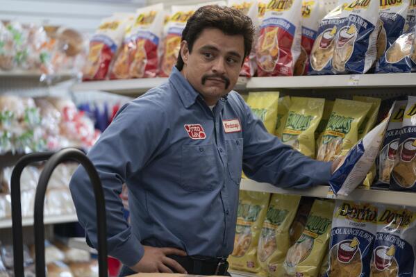 This image released by Searchlight Pictures shows Jesse Garcia in a scene from "Flamin' Hot," a tale of how a Mexican American janitor came up with the idea for Flamin’ Hot Cheetos. (Emily Aragones/Searchlight Pictures via AP)