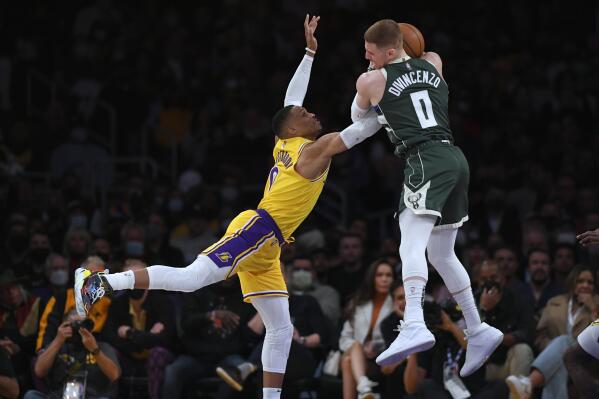Los Angeles Lakers guard Russell Westbrook (0) and Milwaukee Bucks guard Donte DiVincenzo (0) vie for the ball during the second half in an NBA basketball game Tuesday, Feb. 8, 2022, in Los Angeles. (AP Photo/John McCoy)
