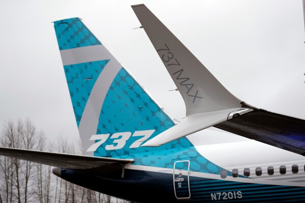 FILE- In this Feb. 5, 2018, file photo, a dual-tipped wing tip, known as a "winglet," stands in view of the tail of a Boeing 737 MAX 7, the newest version of Boeing's fastest-selling airplane, while displayed during a debut for employees and media of the new jet in Renton, Wash. Boeing is asking airlines to inspect its 737 Max jets for a potential loose bolt in the rudder control system, the airplane maker and Federal Aviation Administration confirmed this week, Friday, Dec. 29, 2023. (AP Photo/Elaine Thompson, File)