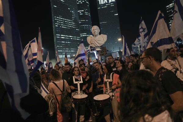 FILE - People hold a bust of Israeli Prime Minster Benjamin Netanyahu depicted as Roman emperor in Tel Aviv, Israel, Monday, March 27, 2023. Tens of thousands protested Monday Netanyahu's drive for judicial overhaul plan. Netanyahu's corruption trial has resumed after a month-long break. The resumption refocuses the spotlight on the long-serving leader's legal woes after a wave of protests over his government's plan to overhaul the country's judiciary. (AP Photo/Oded Balilty, File)