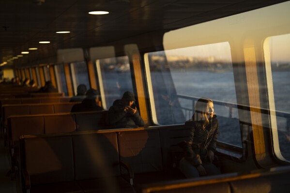 Commuters take a ride in a ferry crossing the Bosphorus in Istanbul, Turkey, Tuesday, Feb. 20, 2024. (AP Photo/Francisco Seco)
