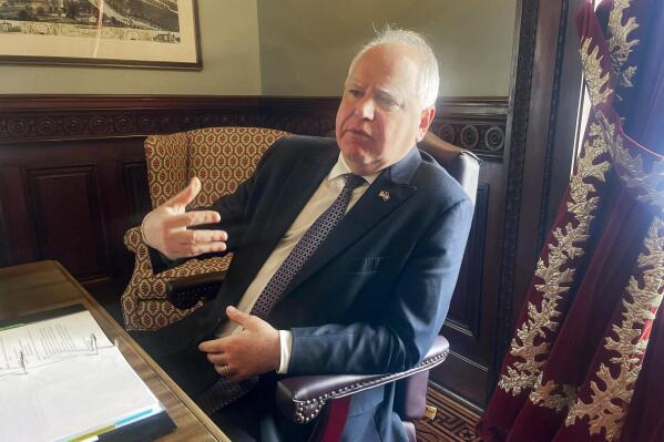 Minnesota Gov. Tim Walz sits for an interview with The Associated Press at his office in the state Capitol on Friday, Jan. 6, 2023, in St. Paul, Minn. Walz said his upcoming budget proposal will include tax rebates from the state's enormous $17.6 billion budget surplus, but conceded that the payments will be smaller that he once hoped. (AP Photo/Trisha Ahmed)