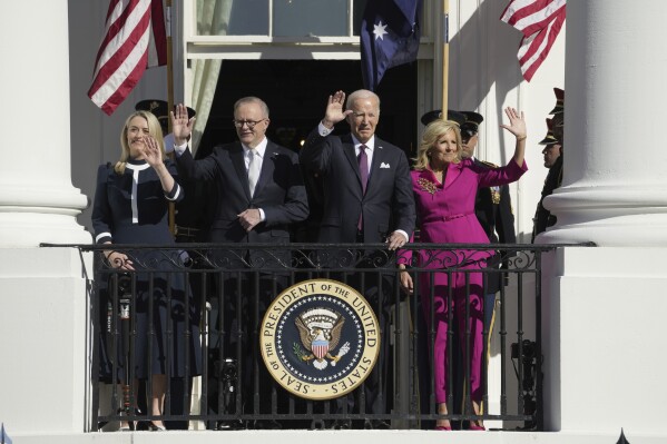 President Joe Biden and first lady Jill Biden, along with Australia's Prime Minister Anthony Albanese and his partner Jodie Haydon, wave from the Blue Room Balcony during a State Arrival Ceremony on the South Lawn of the White House, Wednesday, Oct. 25, 2023, in Washington. (AP Photo/Jacquelyn Martin)