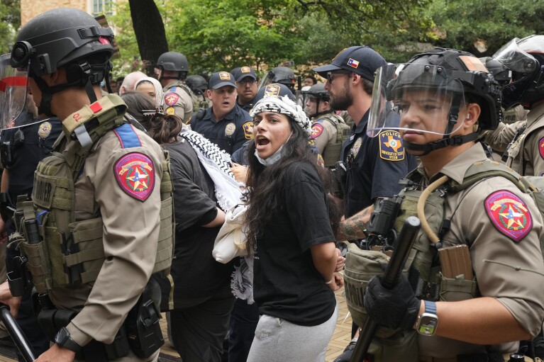 A woman is arrested during a pro-Palestinian protest at the University of Texas, Wednesday, April 24, 2024, in Austin.  (Austin American-Statesman via AP)