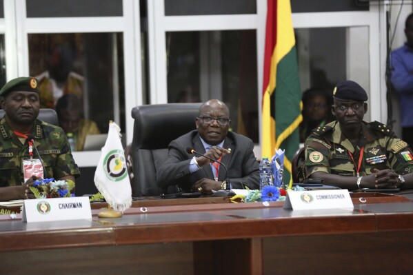 ECOWAS commissioner Abdel-Fatau Musah, centre, speaks during a press briefing following the Extraordinary Meeting of the ECOWAS Committee of Chiefs of the Defence Staff, in Accra, Ghana, Friday, Aug. 18, 2023. Musah announced the ECOWAS forces are ready to act and intervene in Niger should all options fail At left is Nigerian Chief of Defence Staff General Christopher Gwabin Musa, and right is Senegal's General Mbaye Cisse. (AP Photo/Richard Eshun Nanaresh)