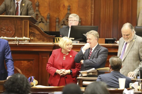 South Carolina House Education and Public Works Committee Chairwoman Shannon Erickson, R-Beaufort, left, and committee researcher Pierce McNair, right, talk during a debate in the House on Wednesday, March, 20, 2024, in Columbia, S.C. (AP Photo/Jeffrey Collins)