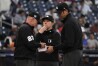 Umpire Jen Pawol, center, stands with fellow umpires Lance Barksdale (23) and Ryan Additon after the exchange of lineup cards before a spring training baseball game between the Washington Nationals and the Houston Astros Saturday, Feb. 24, 2024, in West Palm Beach, Fla. Pawol took a big step toward breaking the gender barrier for Major League Baseball umpires when she became the first woman in 17 years to work a big league spring training game Saturday night. (AP Photo/Jeff Roberson)