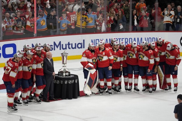 The Florida Panthers pose with the Prince of Wales Trophy after defeating the New York Rangers in Game 6 to win the Eastern Conference finals of the NHL hockey Stanley Cup playoffs Saturday, June 1, 2024, in Sunrise, Fla. (AP Photo/Lynne Sladky)