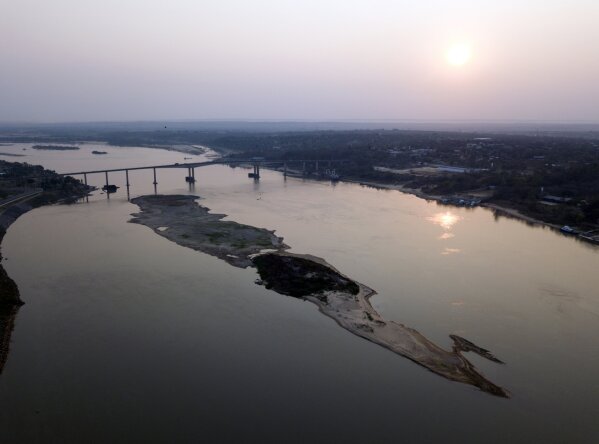 The bottom of the Paraguay River emerges from the water amid historically low water levels near the Remando bridge in Mariano Roque Alonso, Paraguay, Wednesday, Oct. 7, 2020. The Paraguay River reached its lowest level in 50 years on Friday, Oct. 9, 2020, following months of extreme drought, which has exposed the nation’s economic dependence on the river and limited access to drinking water. (AP Photo/Jorge Saenz)