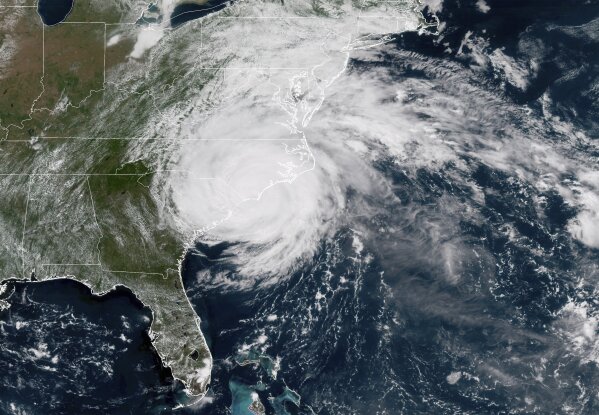 
              This satellite image provided by NOAA shows Hurricane Florence on the eastern coast of the United States on Friday, Sept. 14, 2018. (NOAA via AP)
            