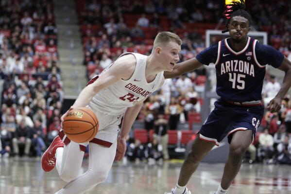 Washington State guard Justin Powell drives while defended by Arizona guard Cedric Henderson Jr. during the second half of an NCAA college basketball game Thursday, Jan. 26, 2023, in Pullman, Wash. Arizona won 63-58. (AP Photo/Young Kwak)