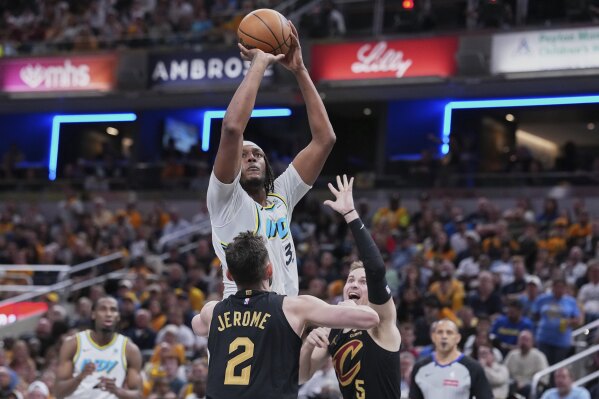 Indiana Pacers center Thomas Bryant (3) shoots over Cleveland Cavaliers guard Ty Jerome (2) in the second half of Game 4 in the Eastern Conference semifinals of the NBA basketball playoffs in Indianapolis, Sunday, May 11, 2025. (AP Photo/Michael Conroy)