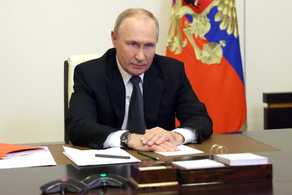 Russian President Vladimir Putin chairs a Security Council meeting via videoconference at the Novo-Ogaryovo residence outside Moscow, Russia, Wednesday, Oct. 19, 2022. (Sergei Ilyin, Sputnik, Kremlin Pool Photo via AP)