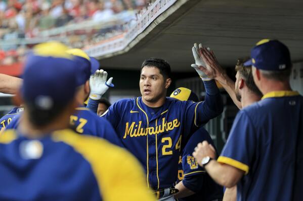 Milwaukee Brewers' Avisail Garcia celebrates with teammates in the dugout after hitting a solo home run during the second inning of a baseball game against the Cincinnati Reds in Cincinnati, Friday, July 16, 2021. (AP Photo/Aaron Doster)