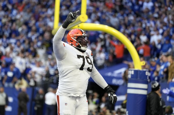 Cleveland Browns offensive tackle Dawand Jones (79) celebrates after a touchdown by teammate Kareem Hunt during the second half of an NFL football game against the Indianapolis Colts, Sunday, Oct. 22, 2023, in Indianapolis. The Browns won 39-38. (AP Photo/Michael Conroy)