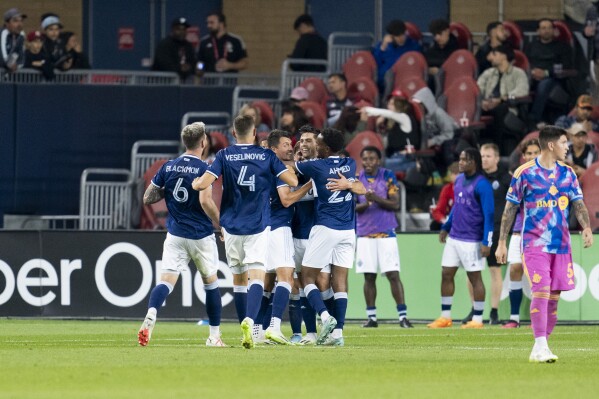Vancouver Whitecaps players celebrate after a goal scored by forward Brian White against Toronto FC during second-half MLS soccer match action in Toronto, Saturday, Sept. 16, 2023. (Spencer Colby/The Canadian Press via AP)