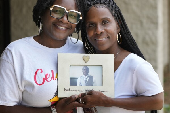 Daphne Myers, right, and her daughter, Latrice Gardner, hold a picture of Myers' son and Gardner's brother, Haston Myers Jr., on June 17, 2023, in Nashville, Tenn. Earlier, the two talked to a group of Meharry Medical College students about Haston Myers' decision to be an organ donor before his death at age 26. A donor representative asked Myers all about her son — how Haston Stafford Myers Jr. always helped others and loved to sing. Only then did Myers learn her son was a registered organ donor and realized she supported his choice. (AP Photo/Mark Humphrey)