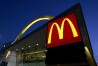 FILE - The McDonald's restaurant logo and golden arch is lit up, April 20, 2006, in Chicago. McDonald’s plans to introduce a $5 meal deal in the U.S. in June 2024 to counter slowing sales and customers’ frustration with high prices. (AP Photo/Jeff Roberson, File)