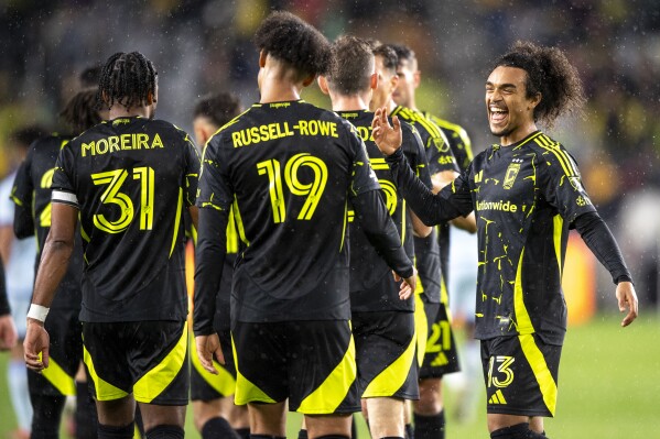 Columbus Crew forward Jacen Russell-Rowe (19) and midfielder Aziel Jackson (13) celebrate after Russell-Rowe scores a goal during the first half of an MLS soccer match against CF Montréal, Saturday, April 5, 2025, in Columbus, Ohio. (AP Photo/Tanner Pearson)
