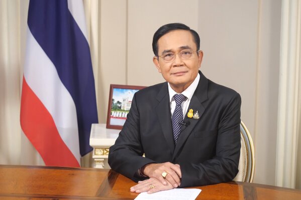 In this photo released by Government House, Thai Prime Minister Prayuth Chan-ocha sits in his office at Government House in Bangkok, Thailand, Wednesday, Oct. 21, 2020. Prayuth on Wednesday pleaded with his countrymen to resolve their political differences through Parliament, as student-led protests seeking to bring his government down continued for an eighth straight day. (Government House via AP)