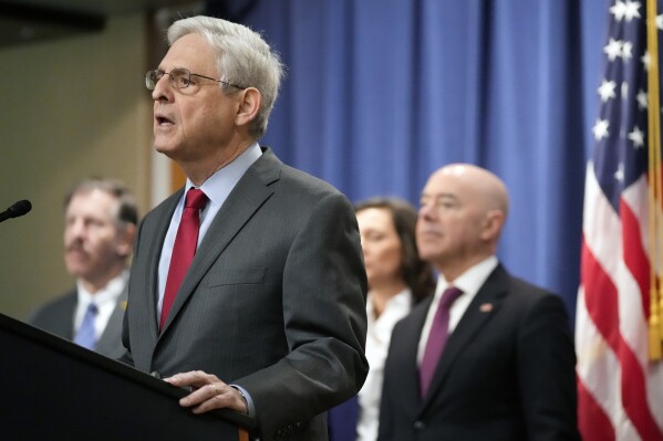 Attorney General Merrick Garland speaks with reporters during a news conference at the Department of Justice, Wednesday, Dec. 6, 2023, in Washington, as Secretary of Homeland Security Alejandro Mayorkas, right, looks on. (APPhoto/Mark Schiefelbein)