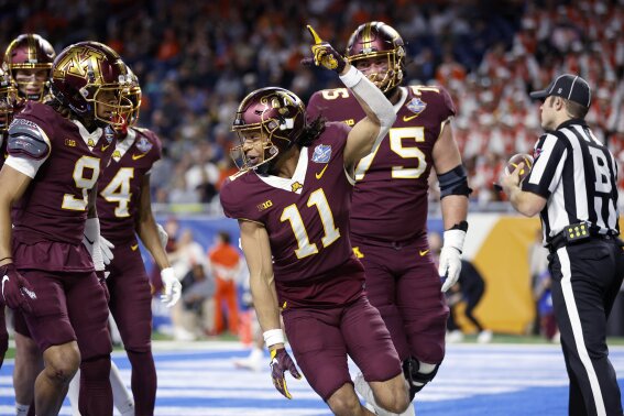 FILE - Minnesota wide receiver Elijah Spencer (11) celebrates his touchdown against Bowling Green during the Quick Lane Bowl NCAA college football game, Tuesday, Dec. 26, 2023, in Detroit.Spencer transferred from Charlotte before last season and had a quiet debut with the Gophers, catching just nine balls for 65 yards. (AP Photo/Al Goldis, File)